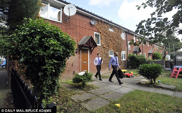 Police probe: Officers were seen leaving the house. The large back and front gardens were strewn with discarded household items and children's plastic toys