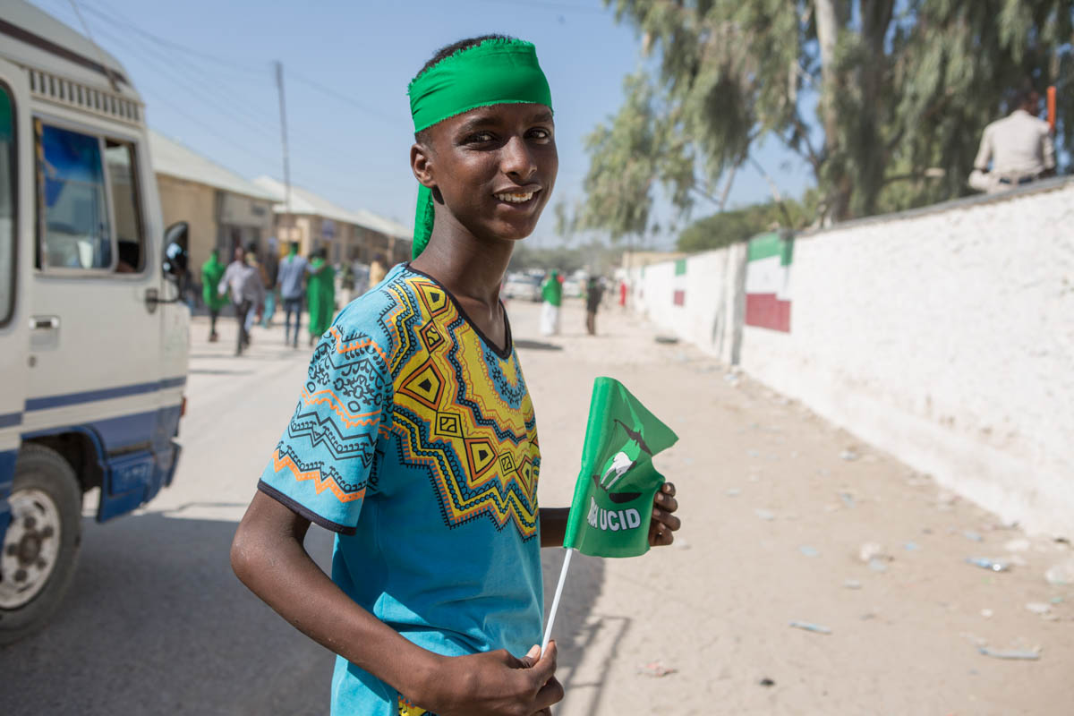 A boy on his way to join an UCID (Justice and Welfare Party) rally in Hargeisa.  Young people in Somaliland have shown a strong interest in politics. 'The youth have energy, and for them politics is new,' says Abdirashid Aliahi Farah, a 26-year-old domestic election observer. 'Some are seeing their first election. In order to get their votes, all the parties say they have youth programmes and that they care about the young.' [Kate Stanworth/Saferworld/Al Jazeera]