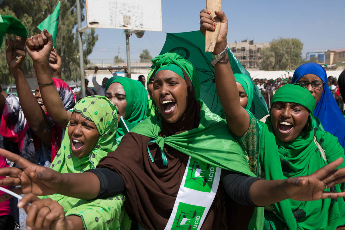 Women chanting and singing joyfully as they wait for their leader’s address at an UCID rally in Hargeisa. [Kate Stanworth/Saferworld/Al Jazeera]