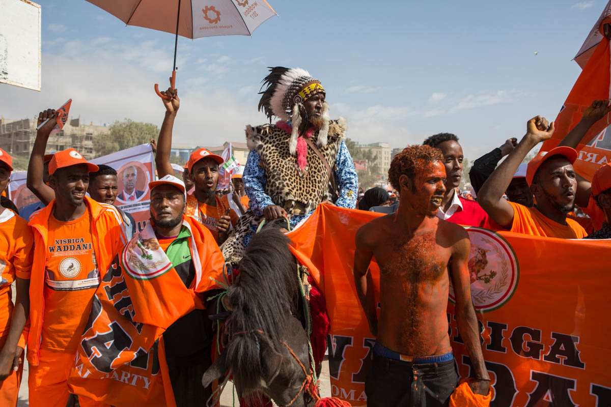 Ahmed Iman Warsame, leader of one of the groups representing so-called ‘occupational castes’ – leatherworkers, metalworkers and haircutters collectively known as the Gabooye – joins a Waddani rally on horseback. Waddani have made the support of minority groups a focus of their campaign.  [Kate Stanworth/Saferworld/Al Jazeera]