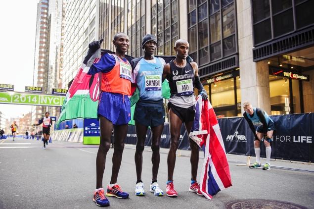 Left to right:  Men’s marathon winners Geoffrey Mutai (first),  Stephen Sambu (third) and  Mo Farah (second) at the finish line of the NYC Half Marathon.