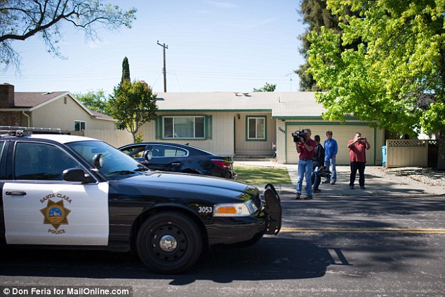 A Santa Clara Police car drives past a house believed to be the home of a boy who stowed away in the wheel well of an airplane is seen on Wednesday, April 23, 2014