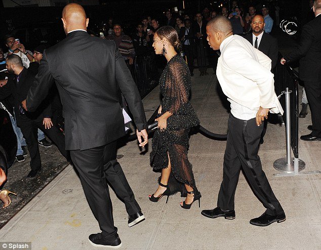 Struggling for composure: Jay Z rights himself as he tails his wife, who is also hot on the heels of her younger sister