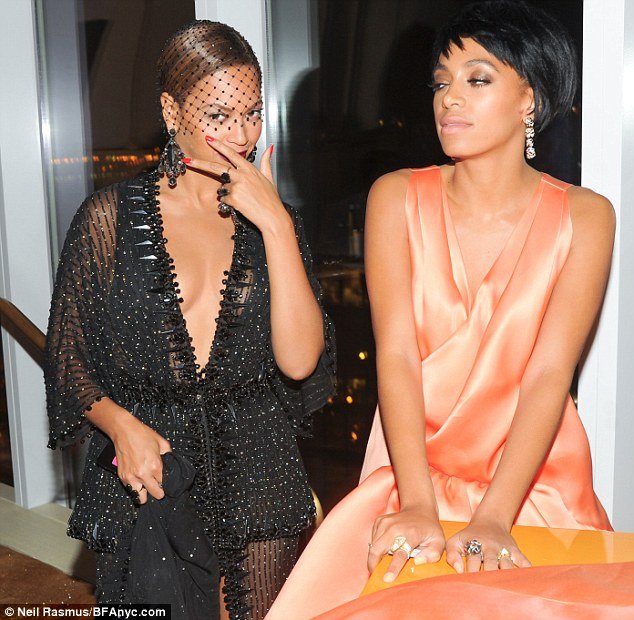 Annoyed: Solange seemed upset by something as she posed for pictures with her sister at the Standard Hotel's Boom Boom room following the Met Gala last week