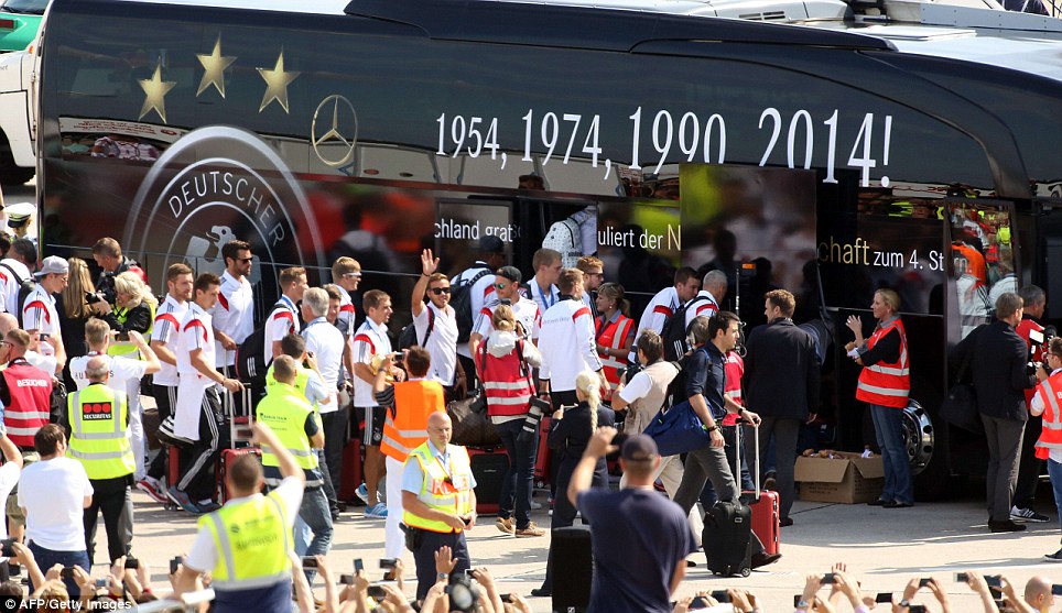 All ready to board? The players are whisked on to a team bus, that includes '2014!' to mark their achievement in South America
