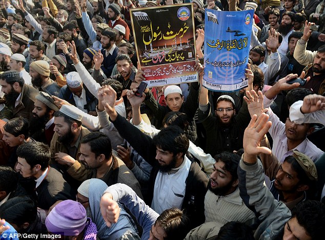 Pakistani protesters shout slogans against the printing of images of the Prophet Muhammed in Lahore