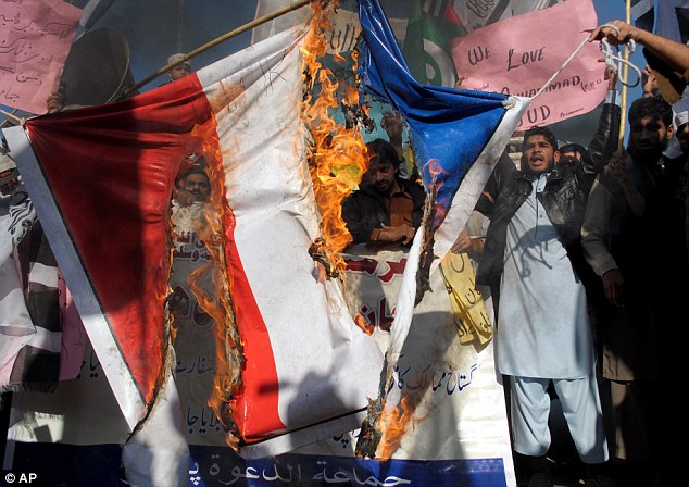 Protesters burned represenations of French flags as Pakisatani officials tried to get them under control using tear gas, batons and water cannons