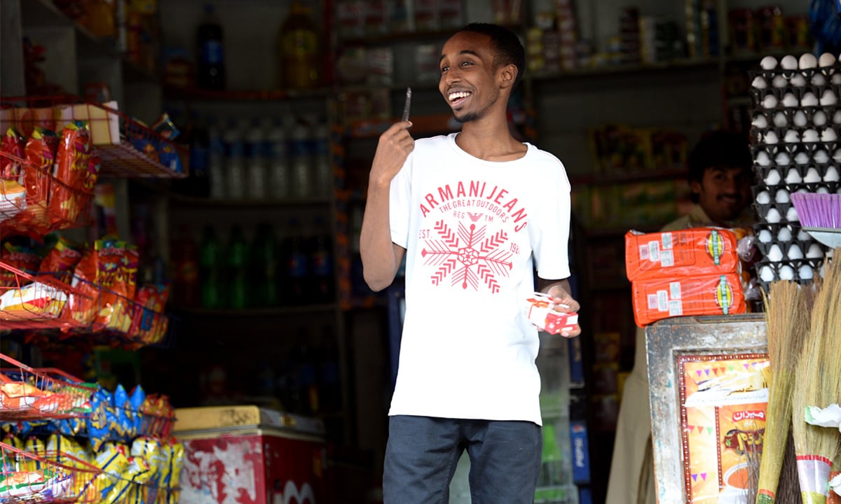 A young Somali man at a store in Islamabad | Taveer Shahzad, White Star