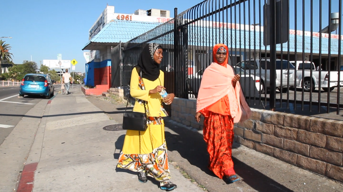 Isha Aweyso and her mother, Nuriya Abshiro walk through the Little Mogadishu district of City Heights.