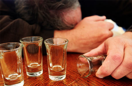 drunk-man-with-empty-shot-glasses460x300