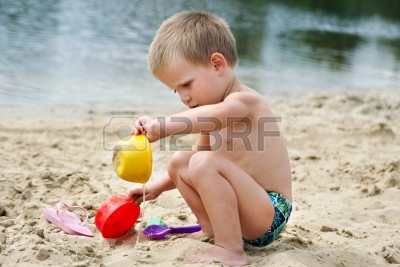 15262007-a-child-playing-in-the-sand-on-