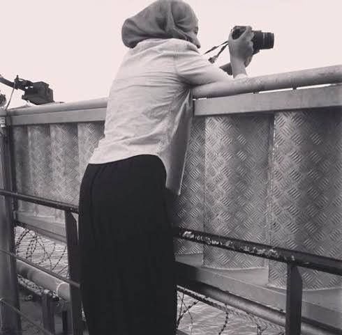 Abla taking landscape pictures of Mogadishu  on board a ship docked in the Sea Port.