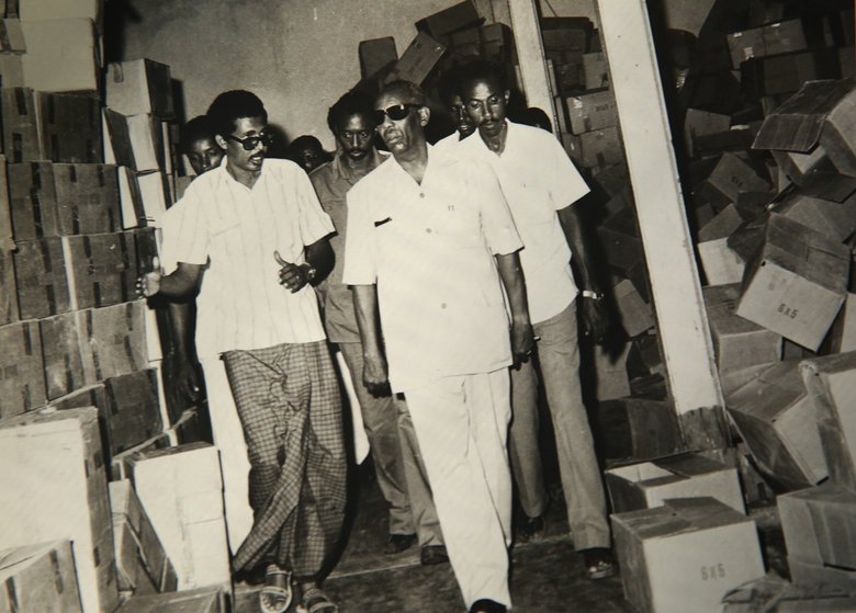 (Photo courtesy of Abdulkadir Aden Mohamud)  Abdulkadir Aden Mohamud, also known as "Jangeli,", left, walks with former Somali president Siad Barre while Mohamud worked as the general manager of a fruit-processing factory in Somalia in 1982. Mohamud later became head of Somalia's development bank.