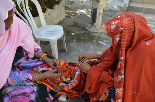 Elderly Somali ladies finalizing on a garment before the wedding