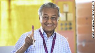 Former Malaysian prime minister and opposition party Pakatan Harapan's candidate Mahathir Mohamad shows his inked finger as he casts his vote Tuesday.