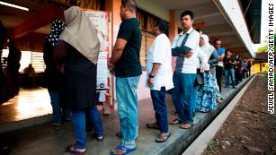 Voters cast their ballots at a polling station during Malaysia's 14th general election on Wednesday. The country's Prime Minister Najib Razak suffered a stunning defeat at the polls.
