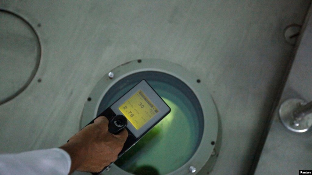 A Libyan representative uses a Geiger counter to measure radiation at the Tajoura nuclear research center...