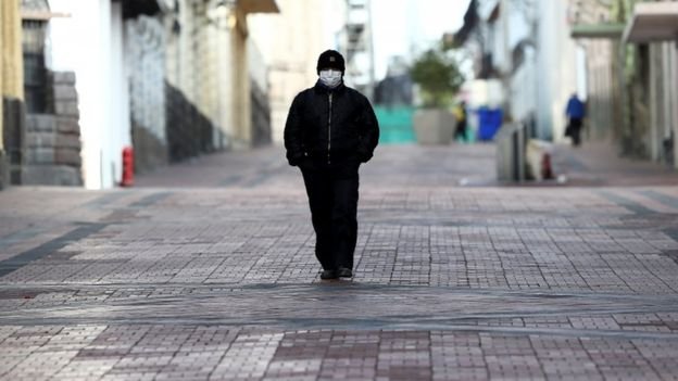 A man walks along a deserted street in Quito, Ecuador