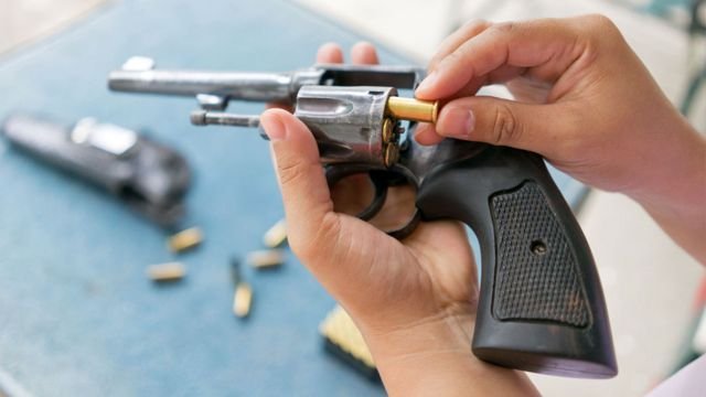 A gun is loaded with ammunition