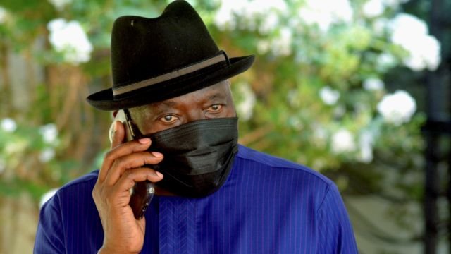 Nigeria's ex-President Goodluck Jonathan wearing a black hat and face mask talking on a phone in Bamako, Mali - Wednesday 26 May 2021
