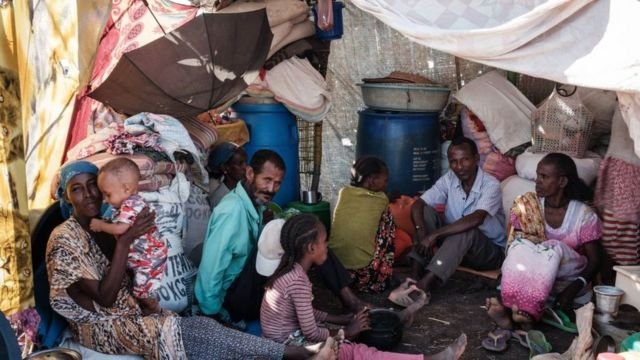 A family of Ethiopian refugees who fled the Tigray conflict rests in a makeshift shelter at the Border Reception Centre in Hamdayet, eastern Sudan, on December 8, 2020