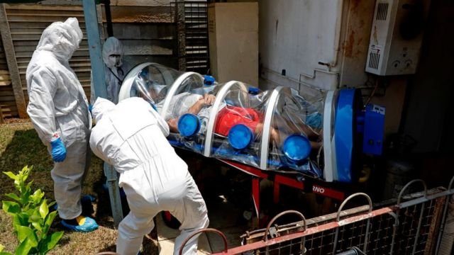 City of Tshwane's Special Infection Unit paramedics and a doctor load a man showing symptoms of COVID-19 coronavirus into the isolation chamber equipped with a negative pressure filtration system from his home in the north of Pretoria, South Africa, on January 15, 2021.