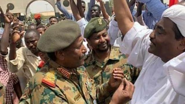 Gen Abdel Fattah Abdelrahman Burhan talks to demonstrators in Khartoum, 12 April