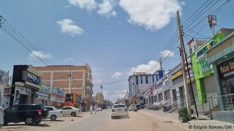 A white car drives through a dusty street in Somaliland's capital, Hargeisa