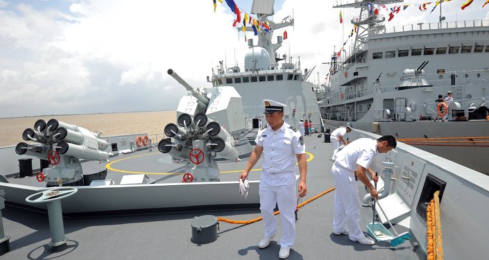 Crew members work on the Chinese Navy ship Wei Fang